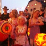 Helena Jessica Maude & others carry illuminated lanterns